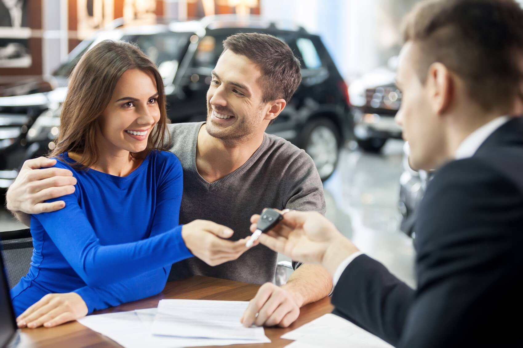 A Couple talking with a car dealer